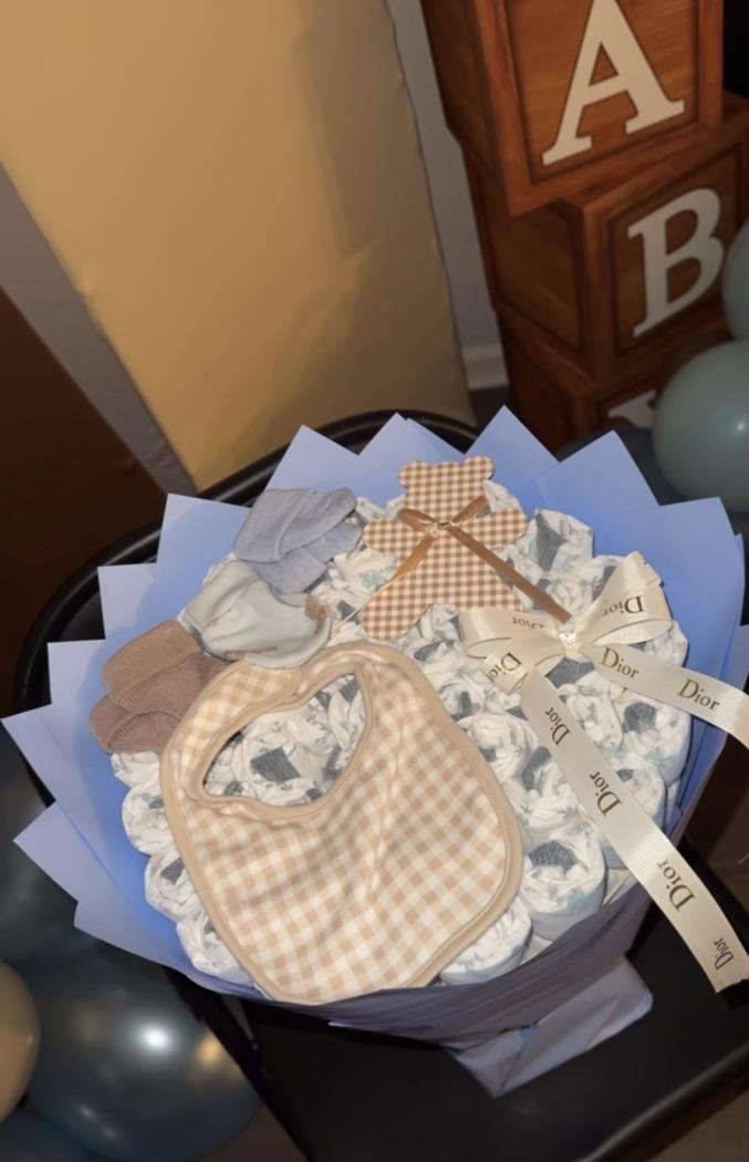 Another view of Flessentials diaper bouquet with baby accessories